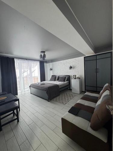 a large bedroom with two beds and a couch at Гостинний двір in Yaremche