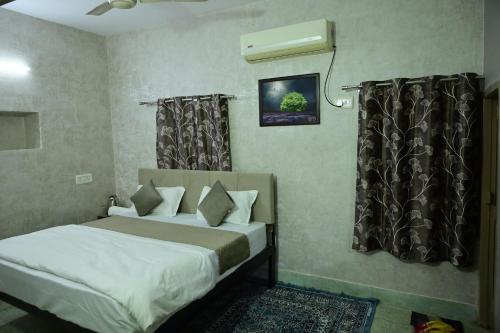 a bedroom with two beds and a air conditioner at The Mapple Stay in Jodhpur