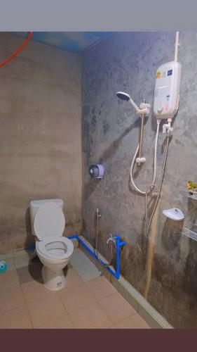 a bathroom with a toilet and a shower stall at Mook Phoopha Guest House in Ko Mook