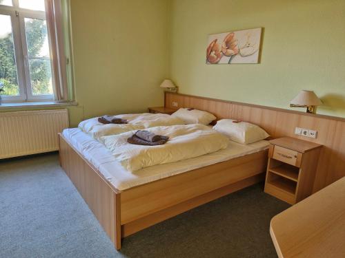 a bedroom with a bed with two pillows on it at Pension Jeschkenblick in Luftkurort Lückendorf