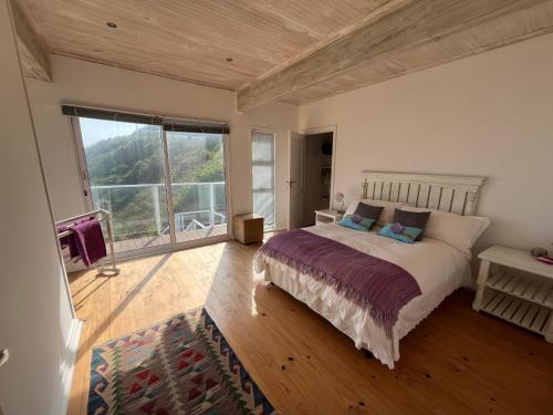 a bedroom with a bed and a large window at 8 Muller st Tergniet in Tergniet