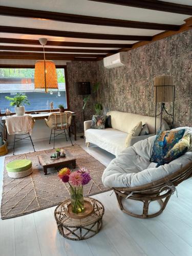 a living room with a couch and a table at Rumah Bersama Kempenbos in Diessen