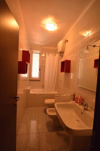 a bathroom with two toilets and a sink and a tub at Ciao Bello B&B in Martina Franca