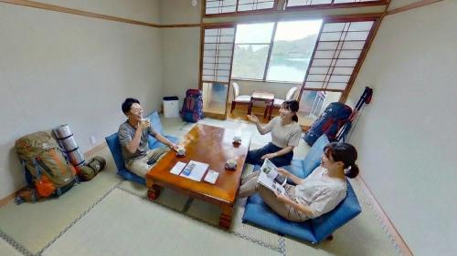 a group of people sitting around a table in a room at H,U,B Unzen - Vacation STAY 74185v in Unzen