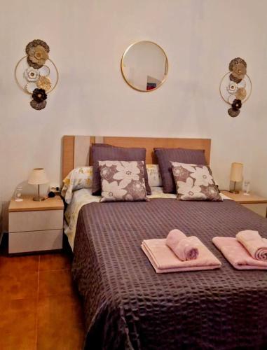 a bedroom with a bed with two towels on it at Casa dos amigos in Chão de Couce