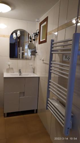 a bathroom with a sink and a mirror at Casa dos amigos in Chão de Couce