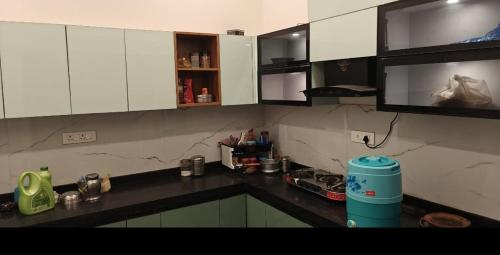 a kitchen with white cabinets and a counter top at Full villa welcome for you in Jaipur