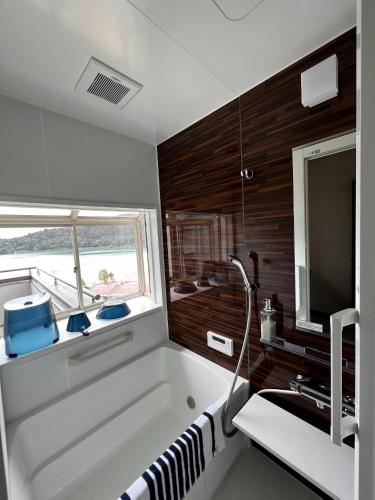 a bathroom with a tub and a sink and a television at H,U,B Unzen - Vacation STAY 01672v in Unzen