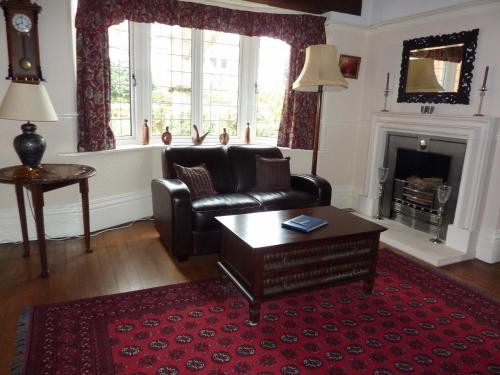 a living room with a couch and a fireplace at The Manse B&B in Eastbourne