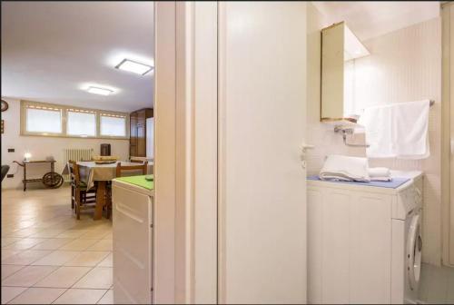 a kitchen with a washing machine and a dining room at Open Space Verona in Verona