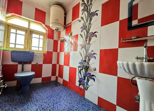 a bathroom with a toilet and a sink at Kashmir naaz in Srinagar