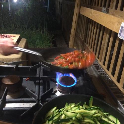 a person cooking food in a pan on a stove at Agriturismo Le Spighe in San Donato