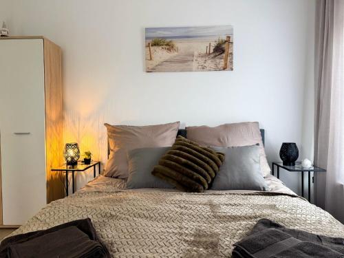 a bedroom with a bed with pillows on it at Apartments Brunsbüttel in Brunsbüttel