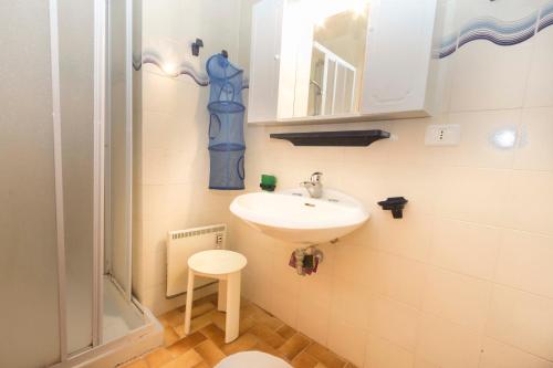 a small bathroom with a sink and a stool at Capo d'Arco - Goelba in Rio Marina