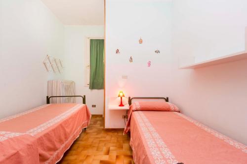 a room with two beds with orange sheets at Capo d'Arco - Goelba in Rio Marina