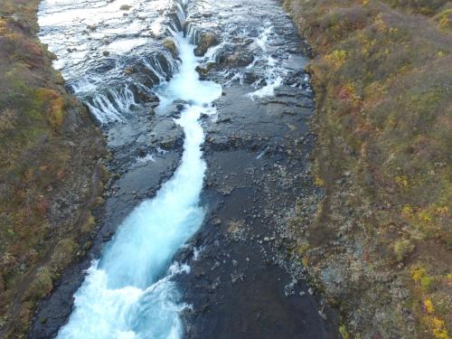 an aerial view of a waterfall on the side of a river at Brekkugisting Villa in Blaskogabyggd