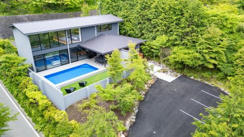 an aerial view of a house with a swimming pool at Villa Cielo Hakone Luxury - Mt Fuji View Private Onsen & Sauna シエロ箱根仙石原 in Hakone