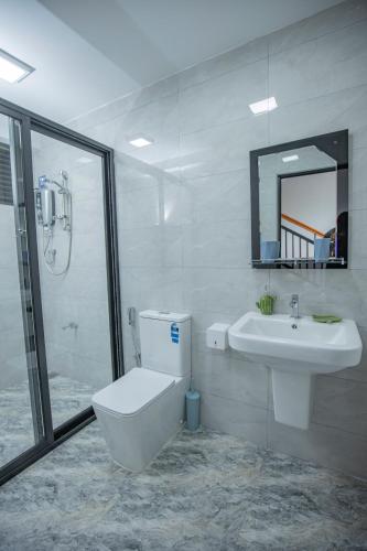 a bathroom with a sink and a toilet and a mirror at Gone4Coastal - Cabana in Hikkaduwa