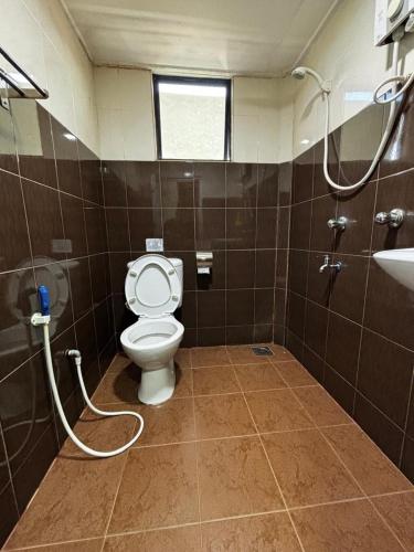a bathroom with a toilet and a sink at Maena Water Chalets in Tumpat