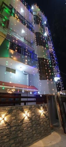 a building with christmas lights on the side of it at Bajrang kutir B in Varanasi