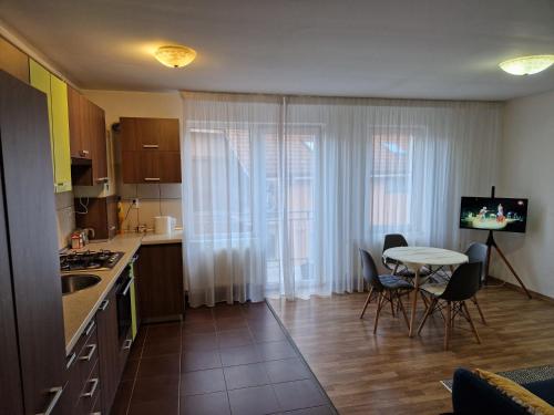 a kitchen with a table and a small table and chairs at COM Home Floresti - Free Parking - 24h Self check-in in Floreşti