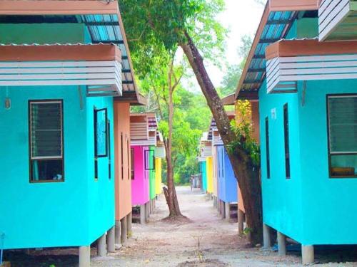 a row of colorful houses on a street at MP Resort Koh Phayam in Ko Phayam