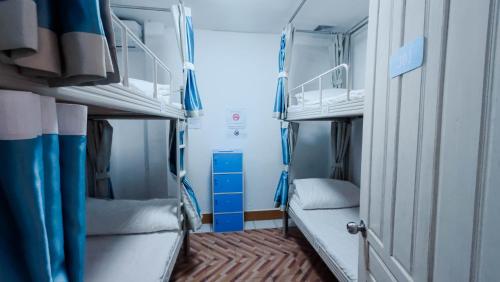 a small room with two bunk beds on a train at Happy Home Hostel 1 in Vientiane