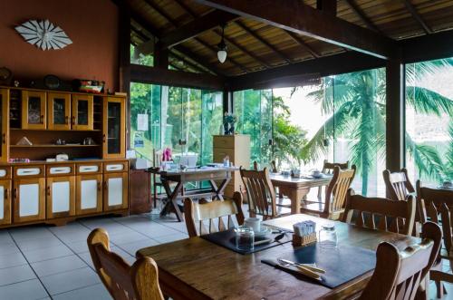 a dining room with a table and chairs at Pousada Portal do Sol in Abraão