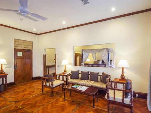 a living room with a couch and a bed at Mount Lavinia Hotel in Mount Lavinia
