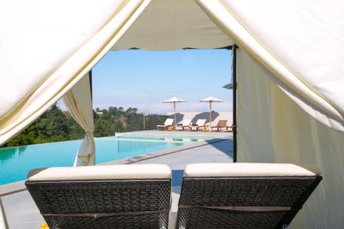 a view of a swimming pool and two chairs at Vale d'Azenha Hotel Rural & Residences in Alcobaça
