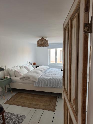 a bedroom with a bed and a window at Südfrankreich bei Berlin in Werder