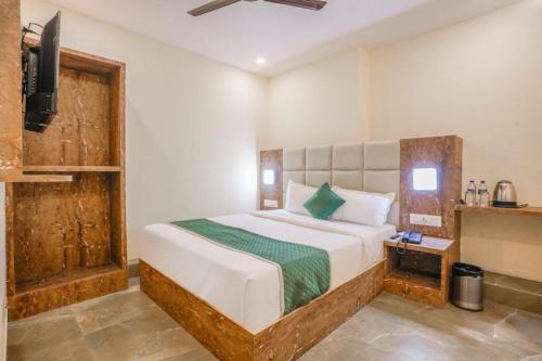 a bedroom with a bed and a television in it at Hotel Crystal By Glitz Hotels in Mumbai