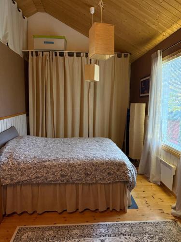 a bedroom with a bed and a large window at Kutala Cottage in Kutala