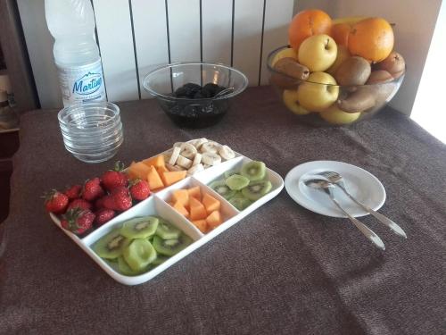 a tray of fruit and vegetables on a table at Hotel Corte Santa Libera in San Fedele Intelvi