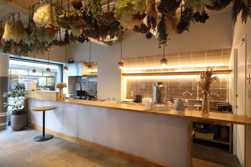 a large kitchen with a counter in a restaurant at E10 Hostel in Tokyo