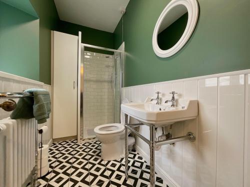 a green bathroom with a sink and a toilet at Apartment in Omagh in Omagh