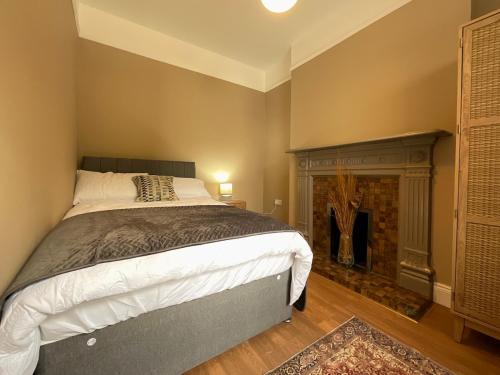 a bedroom with a bed and a fireplace at Apartment in Omagh in Omagh