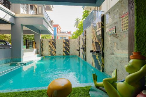 a swimming pool in the middle of a building at Ragvi Resort Alibaug in Nagaon