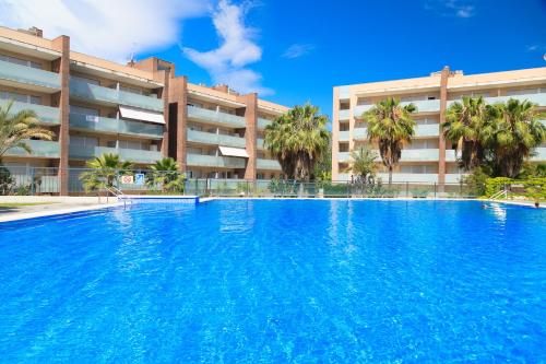 a large swimming pool in front of a building at UHC Spa Aqquaria Family Complex in Salou