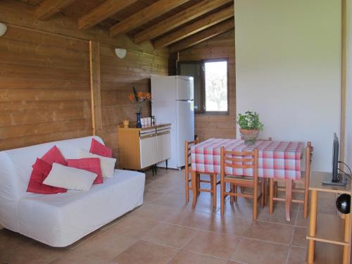 a living room with a white couch and a table at Holiday home Stella di Sicilia in Acquedolci