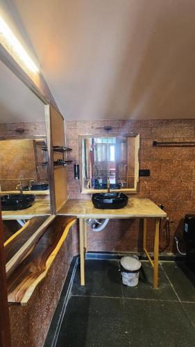 a bathroom with two sinks in a room at Sky Frame Beach Resort in Varkala