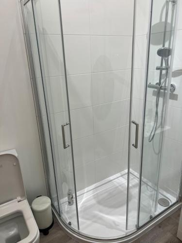 a shower stall in a bathroom with a toilet at Glebe Barn in Cuxham