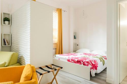 a bedroom with a bed and a yellow chair at AfforiCentro in Milan