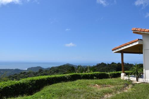 a view of the ocean from a house at Hotel Peace & Lodge in Sámara
