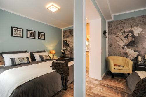 a bedroom with two beds and a chair at Ferienhaus Reuter in Faurndau
