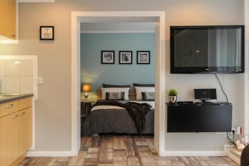 a bedroom with a bed and a flat screen tv at Ferienhaus Reuter in Faurndau