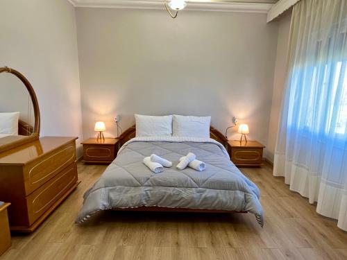 a bedroom with a bed with two towels on it at Mary's Villa in Xanthi