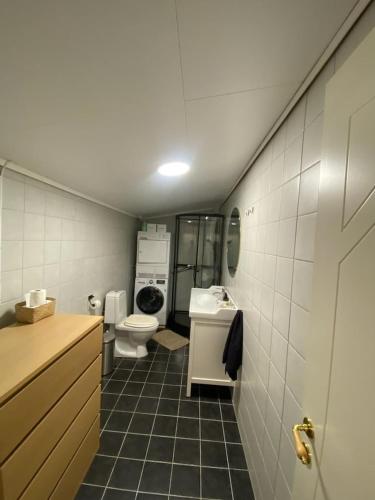 a small bathroom with a toilet and a sink at Furnishe outhouse in Bergen
