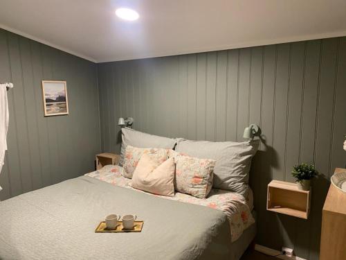 a bedroom with a bed with two candles on it at Furnishe outhouse in Bergen