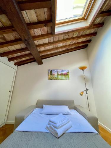 a bedroom with a bed with towels on it at Residenza Zaccone in Tivoli